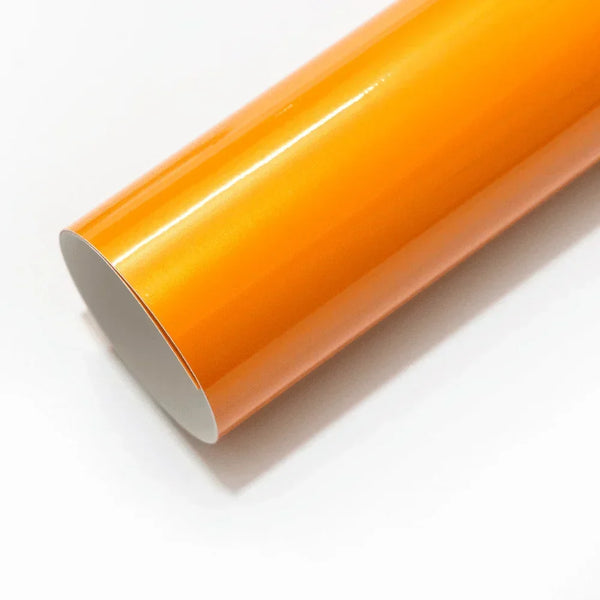 Roll of orange vinyl wrap on a white background