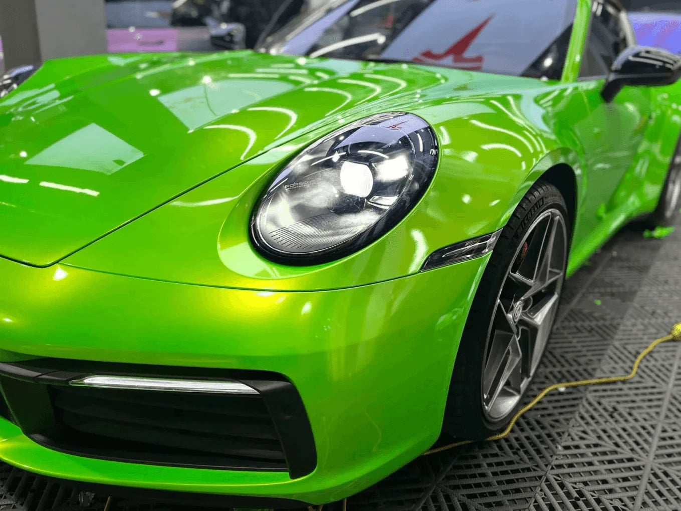 Green sports car in a showroom setting